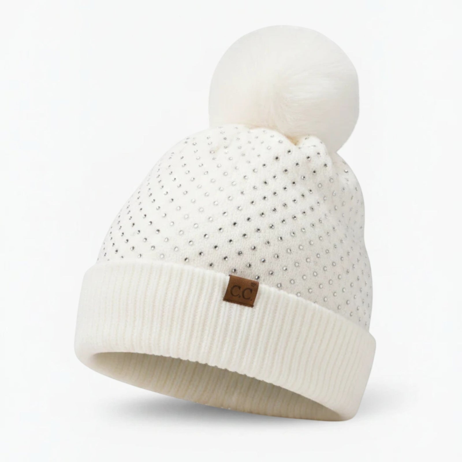 Truly Contagious white C.C. knit beanie with allover rhinestone embellishments and an oversized faux fur pom pom.