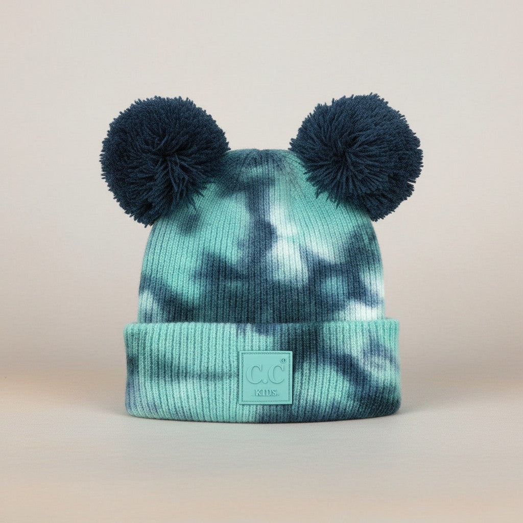 Truly Contagious baby beanie hat with teal and navy tie-dye pattern and two navy blue pom poms.